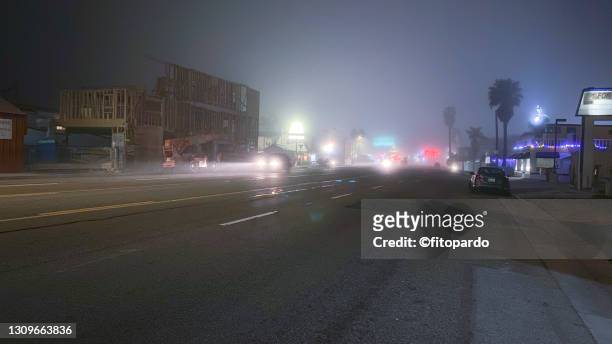 deep fog during the night in sunset beach california - driving in fog stock pictures, royalty-free photos & images