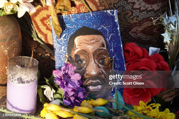 Portrait of George Floyd sits among flowers at a memorial near the site where George Floyd died at the hands of former Minneapolis police officer...