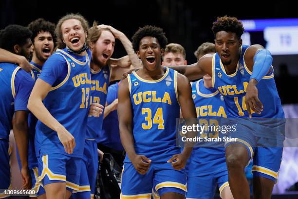 David Singleton of the UCLA Bruins celebrates with Kenneth Nwuba and Mac Etienne after defeating the Alabama Crimson Tide in the Sweet Sixteen round...