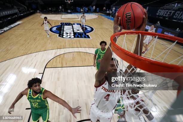 Evan Mobley of the USC Trojans dunks the ball against the Oregon Ducks in the first half of their Sweet Sixteen round game of the 2021 NCAA Men's...