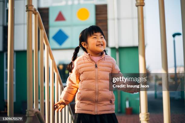 happy little girl having fun in playground - like a child in a sweet shop stock pictures, royalty-free photos & images