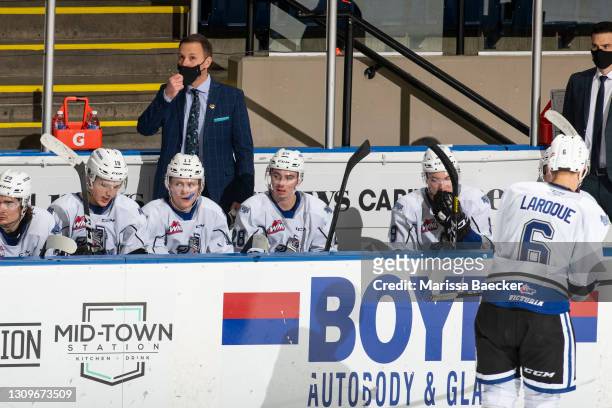 Victoria Royals"u2019 head coach Dan Price stands on the bench during third period looking at the score clock against the Kelowna Rockets at Prospera...