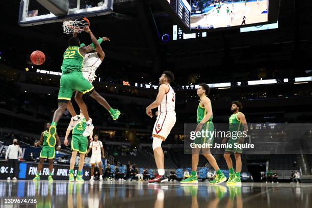 Evan Mobley of the USC Trojans dunks the ball over Franck Kepnang of the Oregon Ducks in the second half of their Sweet Sixteen round game of the...