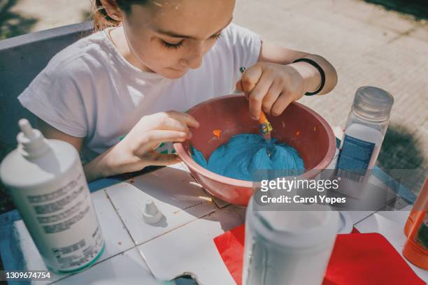 closeup image of girl making some slime in back yard - young thick girls stock-fotos und bilder