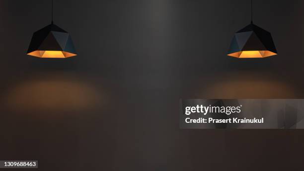 dark wall and light bulb or electricity lamp hanging on ceiling - white lamp foto e immagini stock