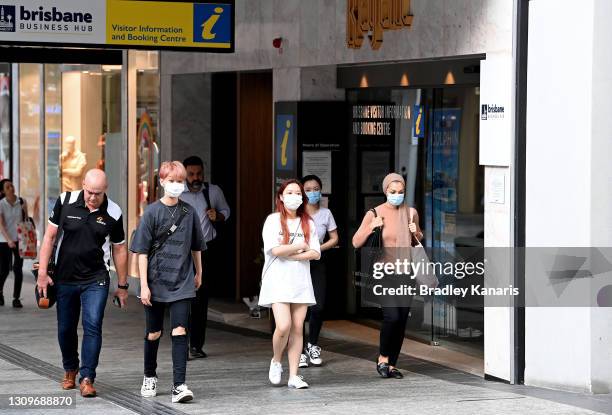 People are seen wearing face masks on the Queen Street Mall in the Brisbane CBD after Queensland Premier Annastacia Palazczuk announced a three-day...