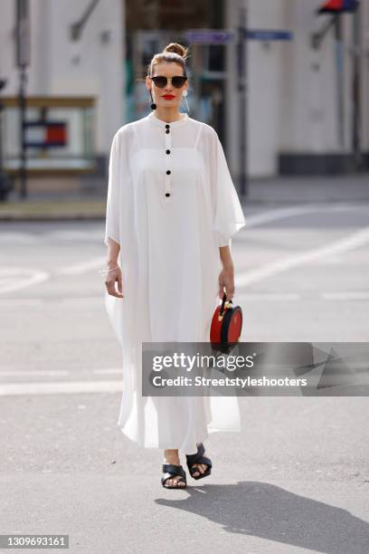 Actress and model Rebecca Kunikowski wearing black and gold sunglasses by Gucci, a silver bracelet and ring by InJewels, black and white earrings by...