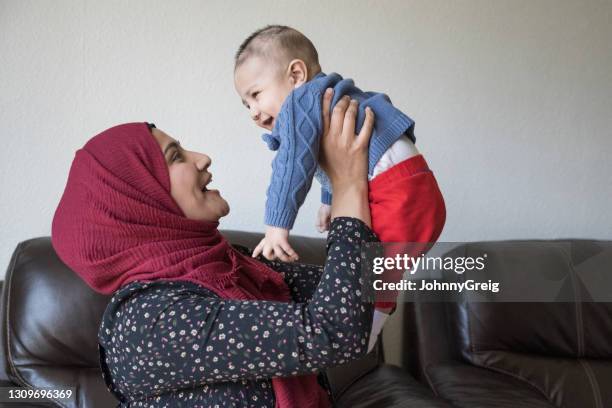 candid portrait of british asian mother with happy baby boy - indian woman with baby stock pictures, royalty-free photos & images