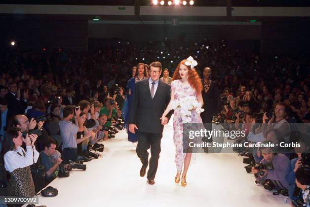 Fashion designer Yves Saint Laurent and a model walk the runway during the Yves Saint Laurent Ready to Wear Spring/Summer 1995 show as part of Paris...