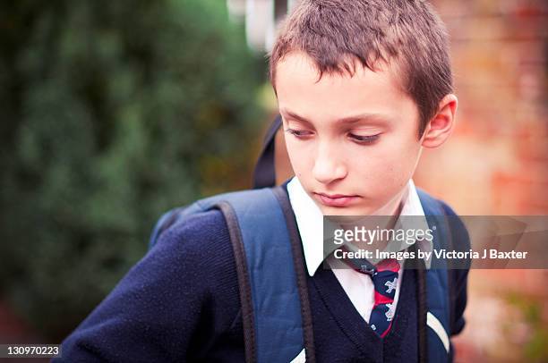 young boy in school uniform - boy wearing backpack stock pictures, royalty-free photos & images