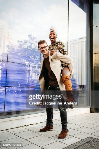 Man giving boy piggyback ride Man giving boy piggy back ride against white  background, model