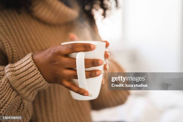 university student with hot coffee at home - black mug stock pictures, royalty-free photos & images