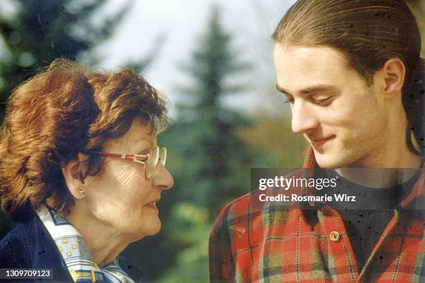 grandmother and nephew facing each other - 90s teens stock pictures, royalty-free photos & images