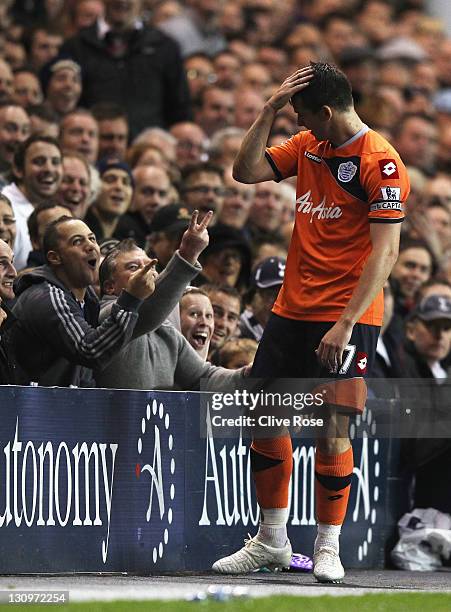 Tottenham Hotspur fans gesture towards Joey Barton of Queens Park Rangers during the Barclays Premier League match between Tottenham Hotspur and...