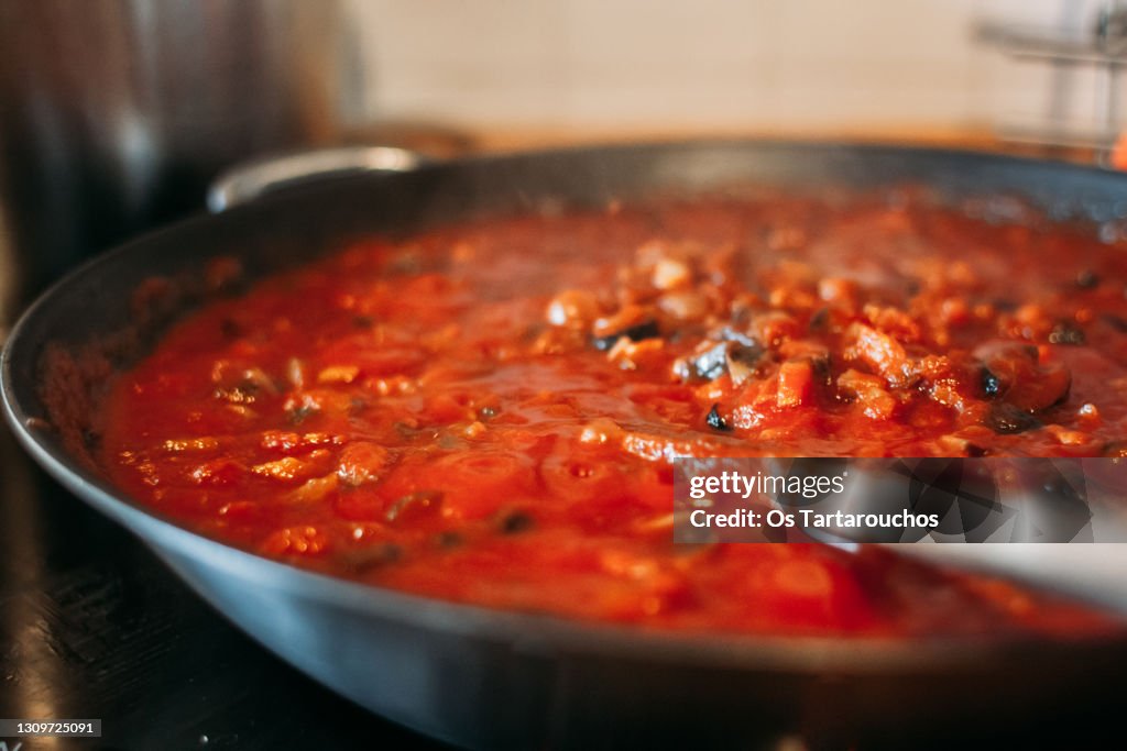 Close up of tomato and vegetables sauce in a pan on the kitchen