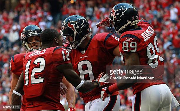 Matt Schaub of the Houston Texans celebrates a touchdown with Jacoby Jones and Bryant Johnson against the Jacksonville Jaguars at Reliant Stadium on...