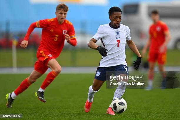 Karamoko Dembele of England tracked by Tom Davies of Wales during the International Friendly match between Wales U18 and England U18 at Leckwith...