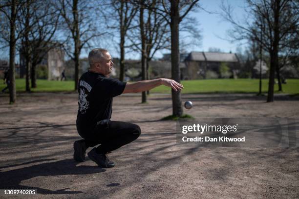 Members of a Petanque club play in Vauxhall pleasure gardens on March 29, 2021 in London, United Kingdom. Today the government eased its rules...