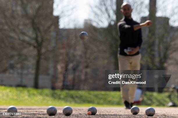 Members of a Petanque club play in Vauxhall pleasure gardens on March 29, 2021 in London, United Kingdom. Today the government eased its rules...