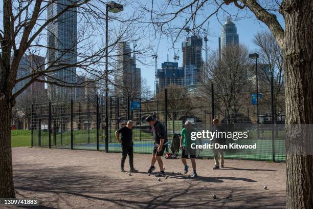 Members of a Petanque club play in Vauxhall pleasure gardens on March 29, 2021 in London, United Kingdom. Today the government eased its rules...