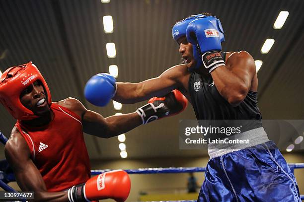 Julio la Cruz , of Cuba, and Yamaguchi Florentino , of Brazil, in action during the final of the 81kg Light Heavy category of boxing competition as...