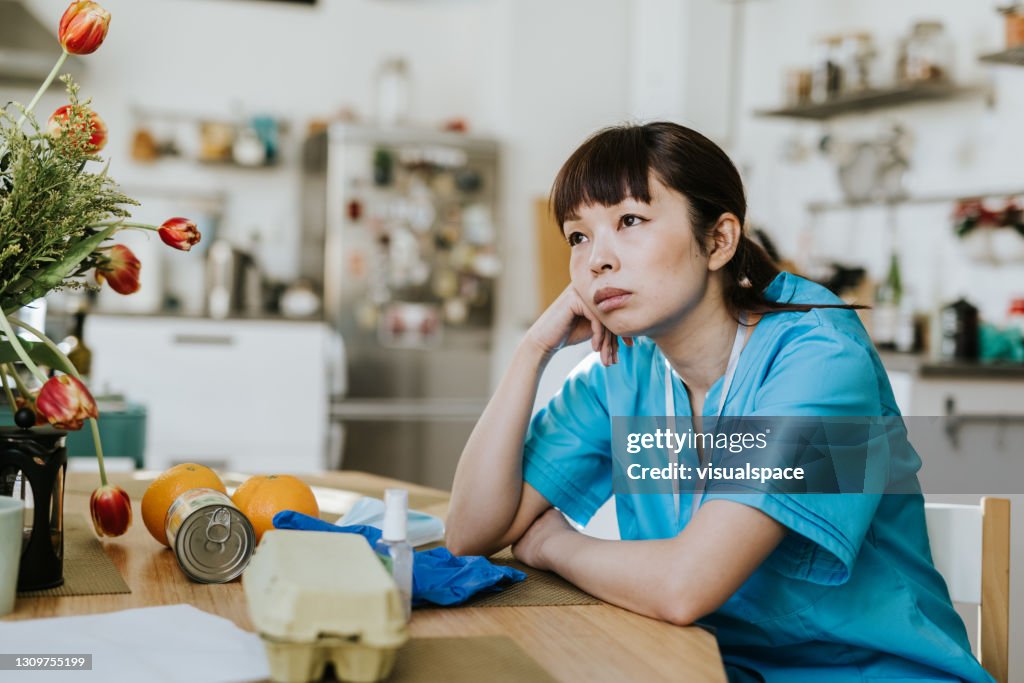 Overworked healthcare worker stressed at home