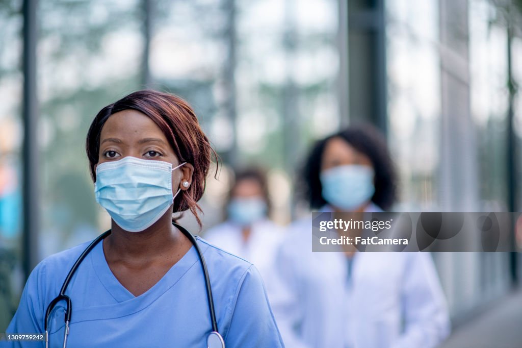 African female nurse wearing a face mask
