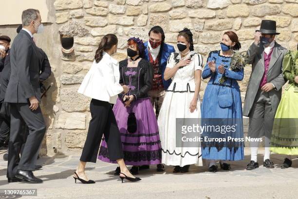 Queen Letizia of Spain and King Felipe VI of Spain approach a group of women dressed in traditional costumes after their visit to Goya's birthplace...