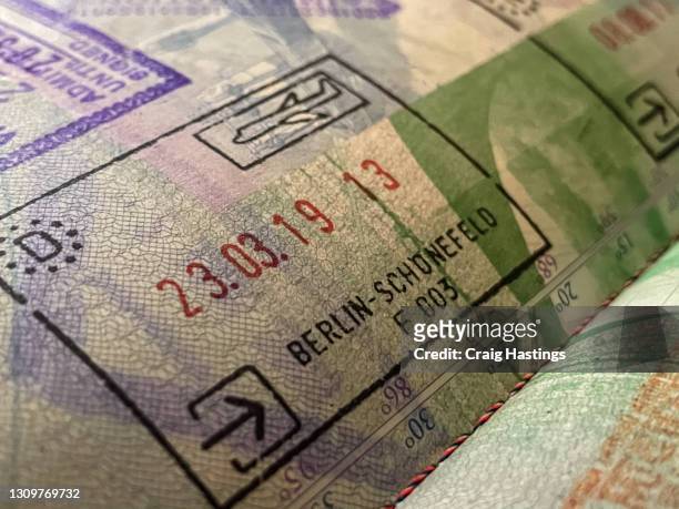 close up opened passport with entry stamps for berlin germany - german passports stock-fotos und bilder