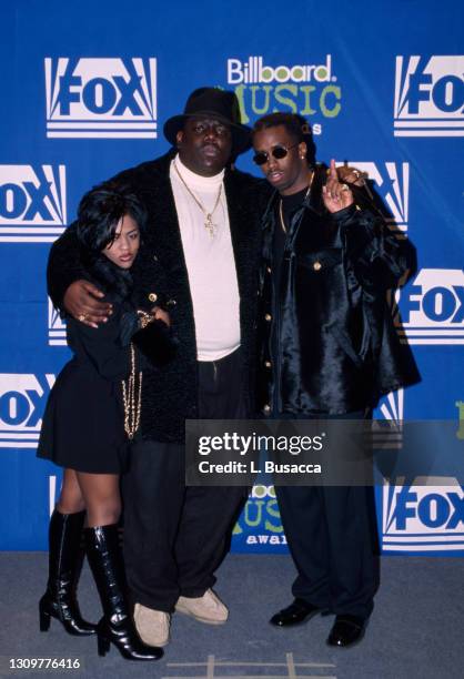 Rapper Notorious B.I.G. AKA Biggie Smalls joined by Sean Combs and Lil' Kim receives Billboard Music Award on December 6, 1995 at The Coliseum in New...