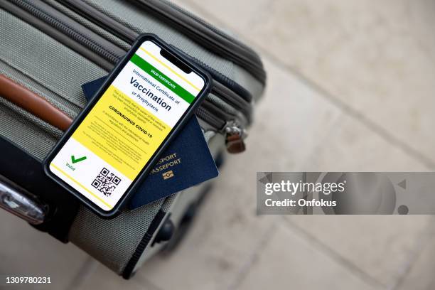 digital vaccine passport app in mobile phone for travel during covid-19 pandemic - airport smartphone stock pictures, royalty-free photos & images