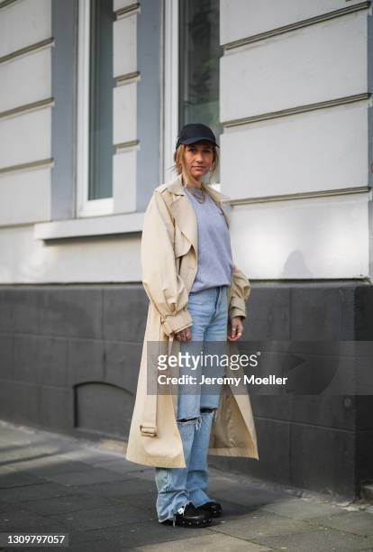Michi Brandl wearing grey La Marel sweater, Zara blue jeans, beige Edited trenchcoat, Scholl Iconic clogs and Prada cap on March 25, 2021 in Cologne,...