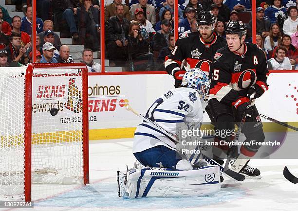 Chris Neil of the Ottawa Senators tips the puck get past Jonas Gustavsson of the Toronto Maple Leafs during an NHL game at Scotiabank Place on...