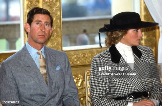 Prince Charles, Prince of Wales and Diana, Princess of Wales, wearing a black and white houndstooth check suit designed by Alistair Blair and a black...