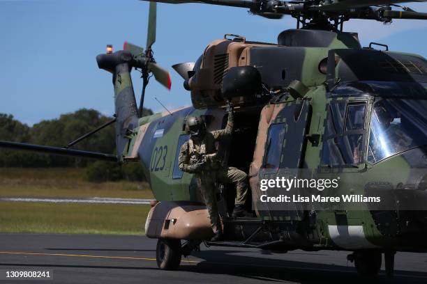 Member of the 5th Aviation Regiment, Townsville is seen aboard a MRH-90 Taipan arriving at Taree Airport as part of flood recovery and assist duties...