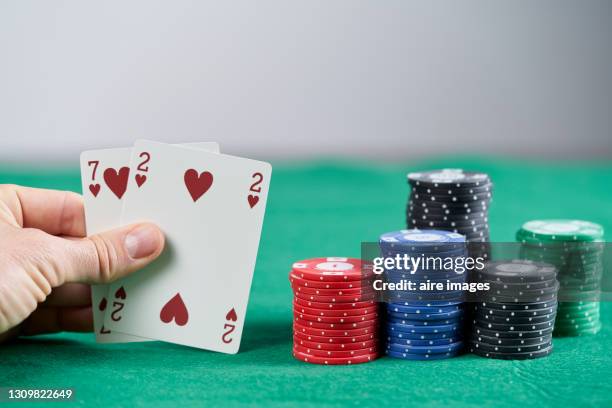 a person showing cards while playing poker. poker game concept. - poker stockfoto's en -beelden