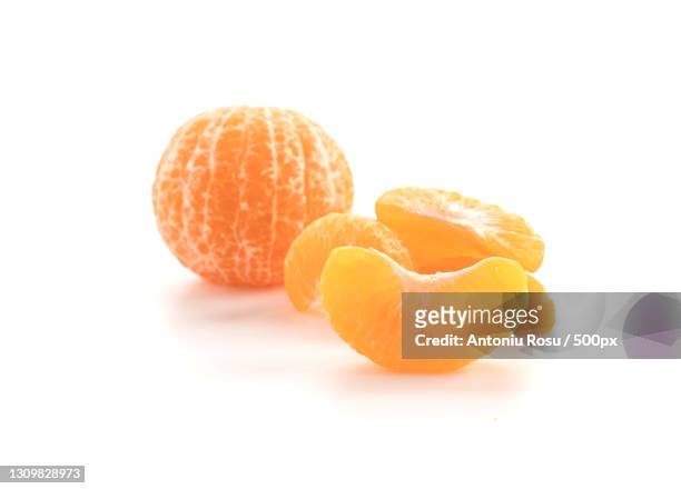 close-up of orange against white background - tangerine stock pictures, royalty-free photos & images