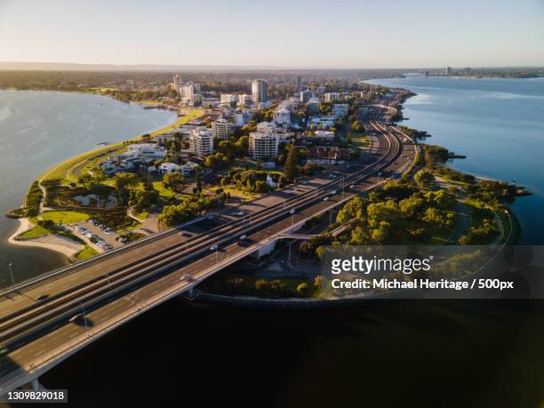 high angle view of city by sea against sky,perth,western australia,australia - perth australia stock pictures, royalty-free photos & images