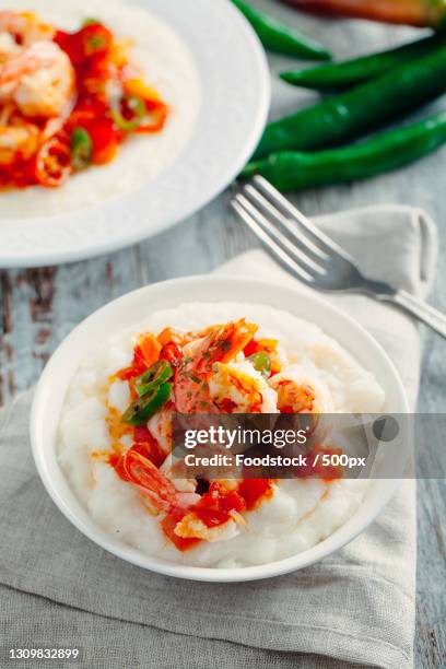 high angle view of food in plate on table - shrimp and grits stock-fotos und bilder