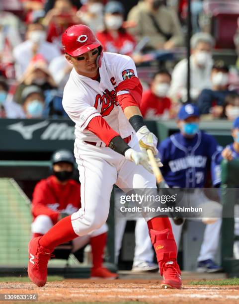 Seiya Suzuki of the Hiroshima Carp hits a RBI single in the 4th inning against Chunichi Dragons at the Mazda Zoom Zoom Stadium Hiroshima on March 27,...