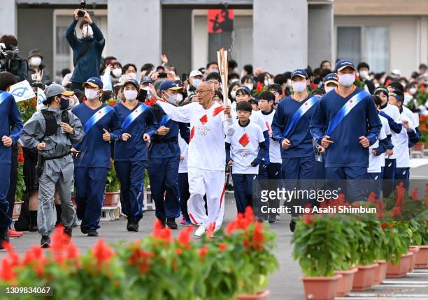 Mexico City Olympic marathon silver medalist Kenji Kimihara runs during the delayed Tokyo 2020 Olympic Games Torch Relay on March 27, 2021 in...