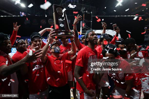 Head coach Kelvin Sampson of the Houston Cougars hoists the trophy after defeating the Oregon State Beavers in the Elite Eight round of the 2021 NCAA...