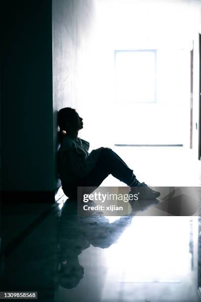 sadness teenage girls sitting in tunnel - loneliness teenager stock pictures, royalty-free photos & images