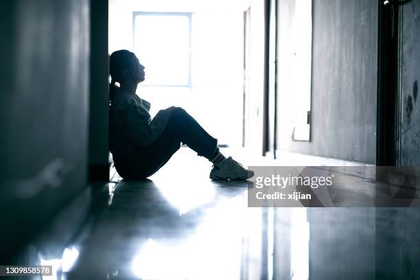 sadness teenage girls sitting in tunnel - depressed teenager stock pictures, royalty-free photos & images