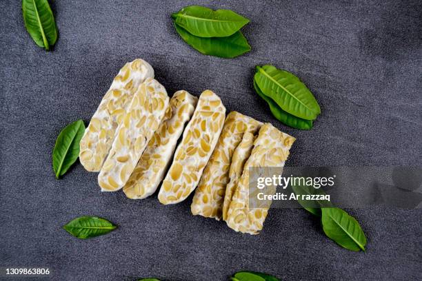 tempe slices with foliage decoration - テンペ ストックフォトと画像