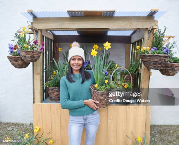 happy asian woman on flower stall. - flower stall imagens e fotografias de stock