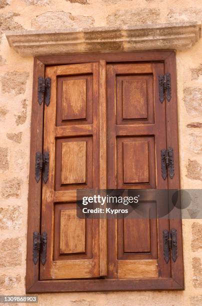 window with wooden shutters on old greek home - open window frame stock pictures, royalty-free photos & images