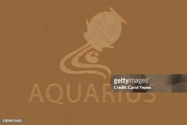 aquarius  horoscope sign in paper craft brown background - signe du verseau photos et images de collection