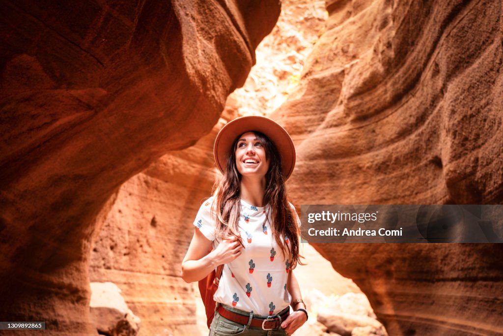 Tourist exploring a canyon in Grand Canary. Canary Islands, Spain