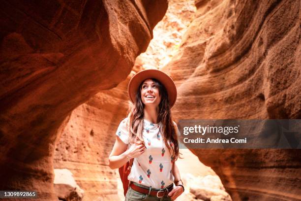 tourist exploring a canyon in grand canary. canary islands, spain - empreendimento turístico - fotografias e filmes do acervo